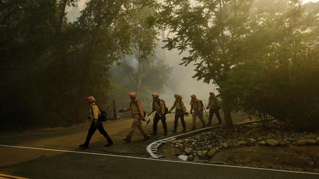 A crew of firefighters on a tactical patrol to assess the situation on June 6. Working round the clock, fire crews were deployed on overnight missions to use the cooler nighttime weather to their advantage but were met with windy conditions on June 7. (Noah Berger / AP)