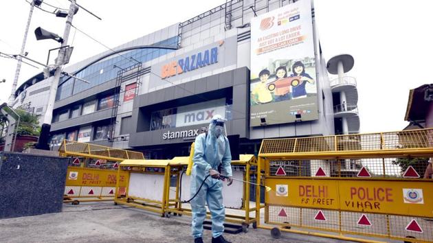 New Delhi, India - June 04, 2020: A worker wearing PPE sprays chemical disinfectant at V3S Mall premises, in Laxmi Nagar, New Delhi (Sonu Mehta/HT PHOTO) New Delhi, India - June 04, 2020: A worker wearing PPE sprays chemical disinfectant at V3S Mall premises, in Laxmi Nagar, New Delhi (Sonu Mehta/HT PHOTO)