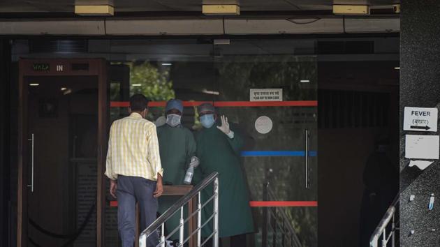 Medical staff in PPE kit screening a person at a hospital in New Delhi, on Sunday. (Sanchit Khanna/HT Photo) Medical staff in PPE kit screening a person at a hospital in New Delhi, on Sunday. (Sanchit Khanna/HT Photo)
