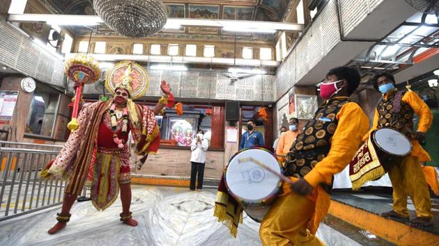 A man dressed as Hindu deity Lord Hanuman, dances inside the Hanuman temple that reopened to devotees in Connaught Place, New Delhi.  (Arvind Yadav / HT Photo) 