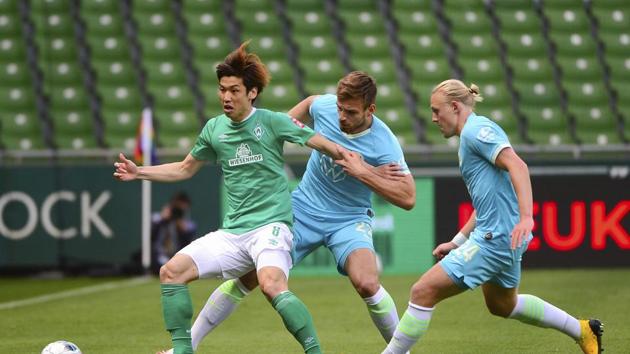 Bremen: Bremen's Japanese forward Yuya Osako, Wolfsburg's Croatian defender Marin Pongracic and Wolfsburg's Austrian midfielder Xaver Schlager , from left,vie for the ball during the German Bundesliga soccer match between Werder Bremen and VfL Wolfsburg in Bremen, Germany, Sunday, June 7, 2020. AP/PTI(AP07-06-2020_000181B)(AP)