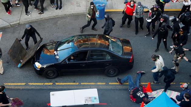 A man falls after being shot by a driver who tried to drive through a protest against racial inequality in the aftermath of the death in Minneapolis police custody of George Floyd, in Seattle, Washington, on June 7. In Washington, D.C., National Guard troops from South Carolina were seen checking out of their hotel Sunday shortly before President Donald Trump tweeted he was giving the order to withdraw them from the nation’s capital. (Lindsey Wasson / REUTERS)