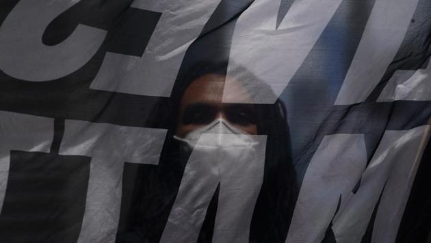 A "Black Lives Matter" New York protester in Times Square on June 7 in New York. On June 6, an estimated 1,600 protesters stopped outside the Trump International Hotel in Manhattan chanting “Throw him out” on their way to Central Park. (Bryan R Smith / AFP)