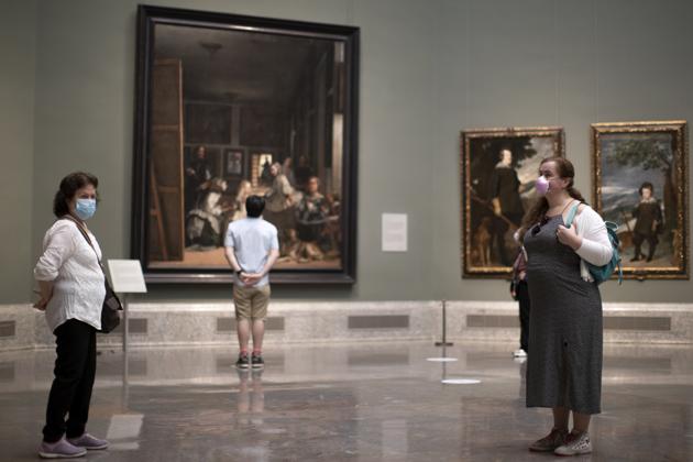 Visitors during the reopening of the Prado museum to the public in Madrid, Spain, Saturday, June 6, 2020. Madrid's Museo del Prado opened its doors on Saturday for 1,800 visitors, after its closing during the coronavirus pandemic. The visitors were required to wear face masks and have their temperature taken before taking in what the museum called its "most iconic works". (AP Photo/Manu Fernandez) (AP) Visitors during the reopening of the Prado museum to the public in Madrid, Spain, Saturday, June 6, 2020. Madrid's Museo del Prado opened its doors on Saturday for 1,800 visitors, after its closing during the coronavirus pandemic. The visitors were required to wear face masks and have their temperature taken before taking in what the museum called its "most iconic works". (AP Photo/Manu Fernandez) (AP)