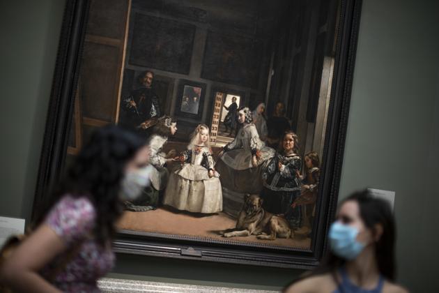 Women stands next to Spanish artist Diego Velazquez's paintings during the reopening of the Prado museum to the public in Madrid, Spain, Saturday, June 6, 2020. Madrid's Museo del Prado opened its doors on Saturday for 1,800 visitors, after its closing during the coronavirus pandemic. The visitors were required to wear face masks and have their temperature taken before taking in what the museum called its "most iconic works". (AP Photo/Manu Fernandez) (AP) Women stands next to Spanish artist Diego Velazquez's paintings during the reopening of the Prado museum to the public in Madrid, Spain, Saturday, June 6, 2020. Madrid's Museo del Prado opened its doors on Saturday for 1,800 visitors, after its closing during the coronavirus pandemic. The visitors were required to wear face masks and have their temperature taken before taking in what the museum called its "most iconic works". (AP Photo/Manu Fernandez) (AP)