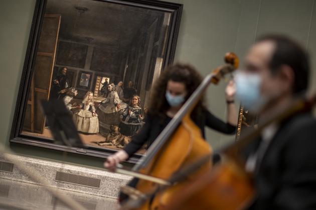 Musicians perform next to Spanish artist Diego Velazquez's paintings during the reopening of the Prado museum to the public in Madrid, Spain, Saturday, June 6, 2020. Madrid's Museo del Prado opened its doors on Saturday for 1,800 visitors, after its closing during the coronavirus pandemic. The visitors were required to wear face masks and have their temperature taken before taking in what the museum called its "most iconic works". (AP Photo/Manu Fernandez) (AP) Musicians perform next to Spanish artist Diego Velazquez's paintings during the reopening of the Prado museum to the public in Madrid, Spain, Saturday, June 6, 2020. Madrid's Museo del Prado opened its doors on Saturday for 1,800 visitors, after its closing during the coronavirus pandemic. The visitors were required to wear face masks and have their temperature taken before taking in what the museum called its "most iconic works". (AP Photo/Manu Fernandez) (AP)