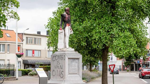 Another statue of King Leopold II of Belgium with a racist graffiti on its side reading ‘Congo is ours’ is pictured in Antwerp after being set on fire. Statues of Leopold have long been a target of activists because of his record of brutal colonial rule in Belgium's former central African colonies. Antwerp took down the statue on June 9, 2020 just days after it was daubed with paint. (Jonas Roosens / Belga / AFP)