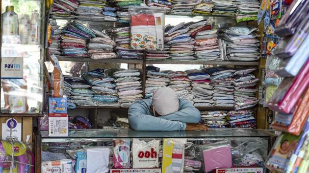 A shopkeeper takes a nap inside his shop amid the lockdown. At least, 11,357 patients have recovered from the highly infectious disease and been discharged from various hospitals. A total of 358 coronavirus patients were discharged in the last 24 hours, reported HT. (Shahbaz Khan / PTI)