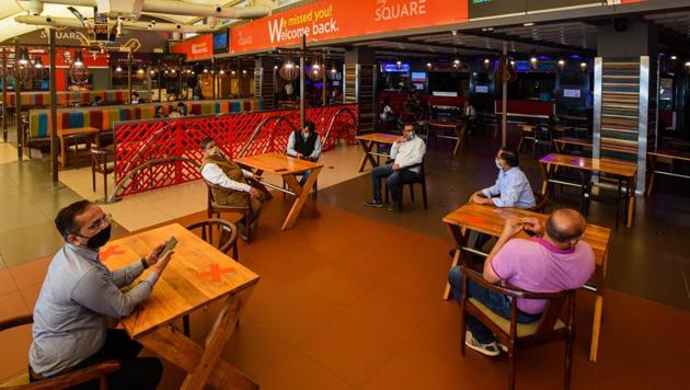 People in the food court at Select Citywalk mall as malls and restaurants reopen to the public following lockdown relaxations in Saket, New Delhi on Monday(Amal KS/HT PHOTO)