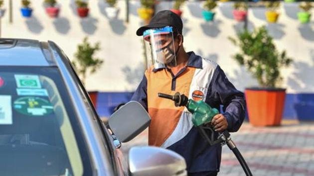 A petrol pump employee wearing a face shield while attending to a customer in Wazirpur, New Delhi on May 5, 2020.(Sanchit Khanna/HT PHOTO)