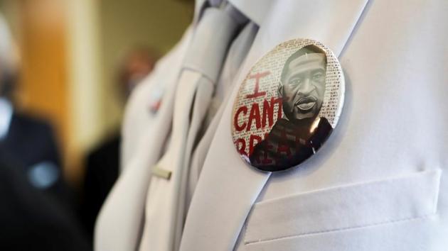 I button that reads "I can't breathe" adorns the jacket of a mourner before the funeral for George Floyd on Tuesday, June 9, 2020, at The Fountain of Praise church in Houston. (REUTERS) I button that reads "I can't breathe" adorns the jacket of a mourner before the funeral for George Floyd on Tuesday, June 9, 2020, at The Fountain of Praise church in Houston. (REUTERS)