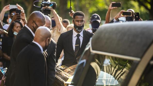 The casket of George Floyd is placed into a hearse at Fountain of Praise church in Houston.(AP) The casket of George Floyd is placed into a hearse at Fountain of Praise church in Houston.(AP)