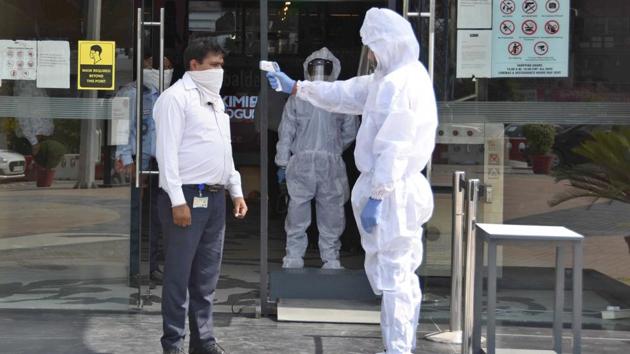 Visitors are thermally screened before entering into a mall in Ludhiana on Monday.(Gurpreet Singh/HT) Visitors are thermally screened before entering into a mall in Ludhiana on Monday.(Gurpreet Singh/HT)