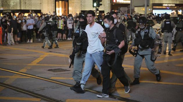 Police detain a man during a rally that was held to mark the first anniversary of pro-democracy protests in Hong Kong. Over the last year, around 9,000 people have been arrested and more than 500 people have been charged with rioting, which would face up to 10 years in jail if convicted, according to an AFP report. (Kin Cheung / AP)