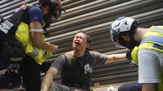 Fellow protesters tend to a man after he was pepper sprayed by the police during a rally. On June 9, organisers of last year’s huge rallies called on the government to lift antivirus restrictions on public gatherings and allow Hong Kongers to march once more, reported AFP. (Vincent Yu / AP)