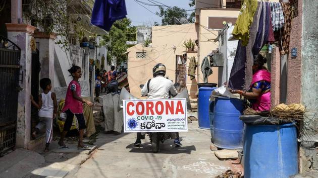 A farmer who tours on his bike in the villages of Telangana state to spread awareness about the COVID-19 coronavirus, rides in the slums in Hyderabad. (AFP) A farmer who tours on his bike in the villages of Telangana state to spread awareness about the COVID-19 coronavirus, rides in the slums in Hyderabad. (AFP)