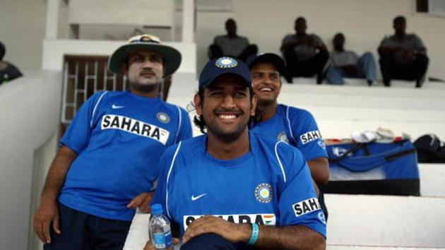 Indian cricketers Virender Sehwag(L), Mahender Singh Dhoni (C) and Suresh Raina(R) smile as they watch other teammates practice.(AFP via Getty Images)