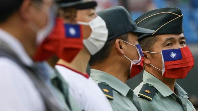 Army representative are seen at the opening of a baseball game with face masks decorated as a Taiwan flag to protect themselves from the coronavirus disease at a professional baseball league game in Taoyuan city, Taiwan.(REUTERS/ For Representative Purposes Only) Army representative are seen at the opening of a baseball game with face masks decorated as a Taiwan flag to protect themselves from the coronavirus disease at a professional baseball league game in Taoyuan city, Taiwan.(REUTERS/ For Representative Purposes Only)