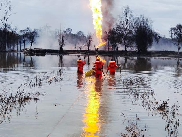 Personnel from NDRF during a search operation for two OIL employees at a pond near a blazing gas well in Assam’s Tinsukia district. (NDRF) Personnel from NDRF during a search operation for two OIL employees at a pond near a blazing gas well in Assam’s Tinsukia district. (NDRF)