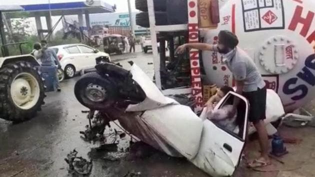 Locals rescuing the injured school principal from the mangled vehicle in Jalandhar on Wednesday. (HT PHOTO) Locals rescuing the injured school principal from the mangled vehicle in Jalandhar on Wednesday. (HT PHOTO)