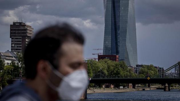 A man walks in front of the European Central Bank in Frankfurt, Germany. If the coronavirus re-emerges later in the year, however, the global economy could shrink 7.6%, the OECD said.(AP) A man walks in front of the European Central Bank in Frankfurt, Germany. If the coronavirus re-emerges later in the year, however, the global economy could shrink 7.6%, the OECD said.(AP)