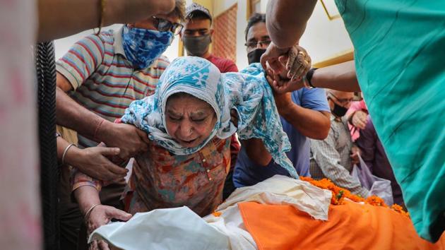 The mother of Kashmiri Pandit sarpanch Ajay Pandita mourns near his mortal remains, at their residence in Jammu on June 9, 2020. Pandita was shot dead Monday evening by terrorists in Anantnag district of South Kashmir.(PTI Photo)