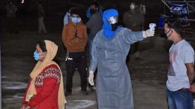 File photo: Migrants from Uttarkashi undergo thermal screening as they arrive at Chinyalisour by government buses. (ANI) File photo: Migrants from Uttarkashi undergo thermal screening as they arrive at Chinyalisour by government buses. (ANI)