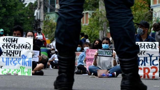 Protesters display placards during a demonstration against the government’s policy on the fight against COVID-19 situation. “The economy is in shambles, the government has pushed our health and the health system in crisis and they have been ineffective and incapable,” Jagannath Lamichhane, a mental health expert who took part in the protest told AFP. (Prakash Mathema / AFP) Protesters display placards during a demonstration against the government’s policy on the fight against COVID-19 situation. “The economy is in shambles, the government has pushed our health and the health system in crisis and they have been ineffective and incapable,” Jagannath Lamichhane, a mental health expert who took part in the protest told AFP. (Prakash Mathema / AFP)