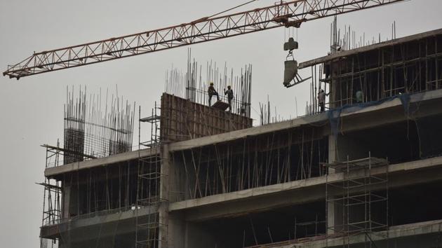 Labourers at work in a building near Gaur Chowk in Noida. (Virendra Singh Gosain/HT File Photo) Labourers at work in a building near Gaur Chowk in Noida. (Virendra Singh Gosain/HT File Photo)