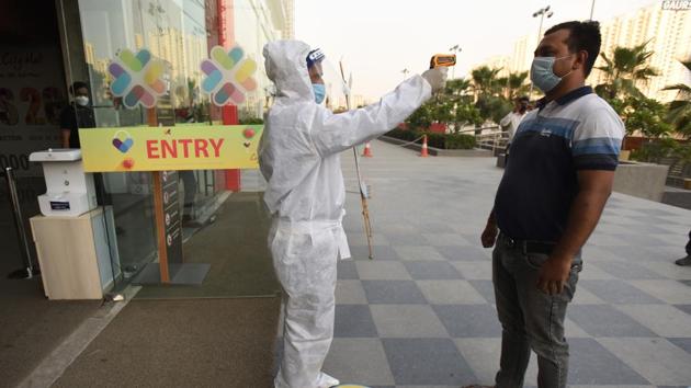 A person is thermal screened while entering Gaur City Mall, in Greater Noida on Tuesday. (Virendra Singh Gosain/HT PHOTO) A person is thermal screened while entering Gaur City Mall, in Greater Noida on Tuesday. (Virendra Singh Gosain/HT PHOTO)