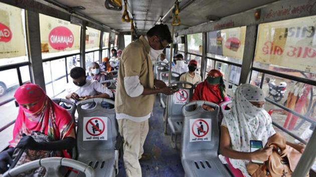 Indians board a city bus in Ahmedabad, India, Wednesday, June 10, 2020. India's coronavirus cases are spiking amid government reopening restaurants, shopping malls and religious places in most of its states after a more than 2-month-old lockdown. (AP Photo/Ajit Solanki) (AP) Indians board a city bus in Ahmedabad, India, Wednesday, June 10, 2020. India's coronavirus cases are spiking amid government reopening restaurants, shopping malls and religious places in most of its states after a more than 2-month-old lockdown. (AP Photo/Ajit Solanki) (AP)