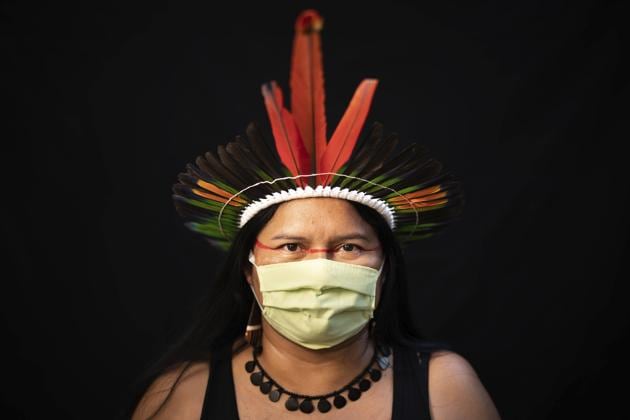 Dilza, 39, of the Sateré Mawé indigenous ethnic group, poses for a portrait wearing the traditional dress of her tribe and a face mask amid the spread of the new coronavirus in Manaus, Brazil, Wednesday, May 27, 2020. (AP Photo/Felipe Dana) (AP) Dilza, 39, of the Sateré Mawé indigenous ethnic group, poses for a portrait wearing the traditional dress of her tribe and a face mask amid the spread of the new coronavirus in Manaus, Brazil, Wednesday, May 27, 2020. (AP Photo/Felipe Dana) (AP)