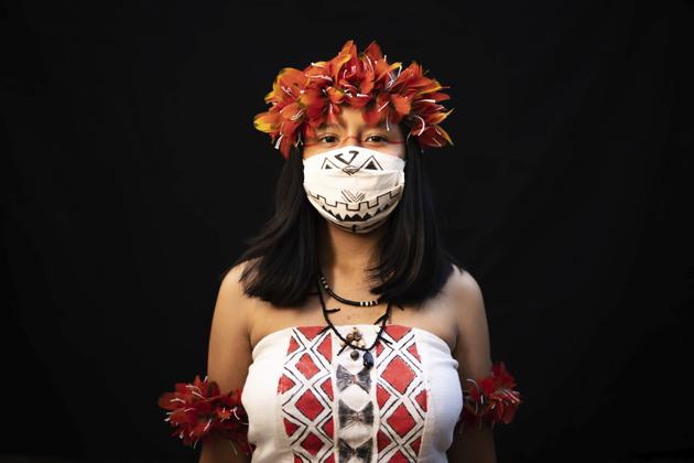 Yusuro Dupohtiro, 15, of the Dessana and Sateré Mawé indigenous ethnic groups, poses for a portrait wearing the traditional dress of her tribe and a face mask amid the spread of the new coronavirus in Manaus, Brazil, Wednesday, May 27, 2020. (AP Photo/Felipe Dana) (AP) Yusuro Dupohtiro, 15, of the Dessana and Sateré Mawé indigenous ethnic groups, poses for a portrait wearing the traditional dress of her tribe and a face mask amid the spread of the new coronavirus in Manaus, Brazil, Wednesday, May 27, 2020. (AP Photo/Felipe Dana) (AP)