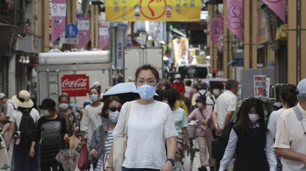People wearing face masks to protect against the spread of the new coronavirus walk at a shopping street in Yokohama, near Tokyo, Wednesday, June 10, 2020. (Representational) (AP) People wearing face masks to protect against the spread of the new coronavirus walk at a shopping street in Yokohama, near Tokyo, Wednesday, June 10, 2020. (Representational) (AP)