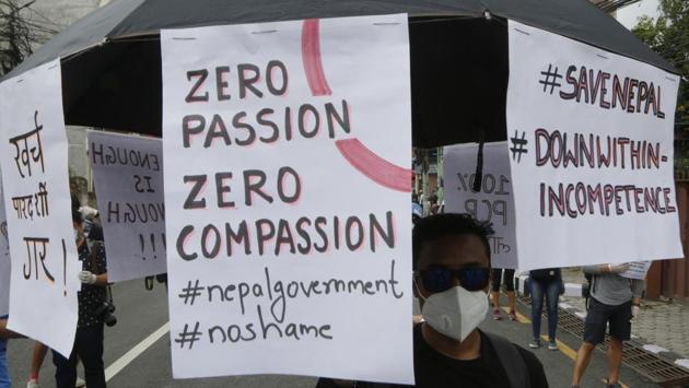 A Nepalese protestor carries an umbrella pinned with placards as they gather for a protest near Prime Minister's residence. “The government had time and could have prepared much better. We were there to call on the government to do better,” photographer Prajwal Bhattarai, 29, who was among those arrested, told AFP on the phone. (Niranjan Shrestha / AP) A Nepalese protestor carries an umbrella pinned with placards as they gather for a protest near Prime Minister's residence. “The government had time and could have prepared much better. We were there to call on the government to do better,” photographer Prajwal Bhattarai, 29, who was among those arrested, told AFP on the phone. (Niranjan Shrestha / AP)