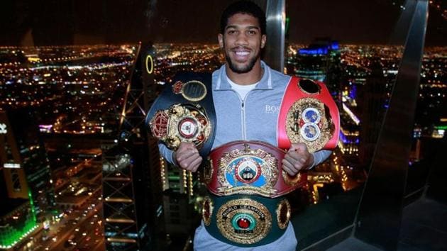 Anthony Joshua poses with the IBF, WBA, WBO & IBO World Heavyweight belts after winning his title fight against Andy Ruiz Jr - Al Faisaliah Tower, Riyadh, Saudi Arabia.(Action Images via Reuters)