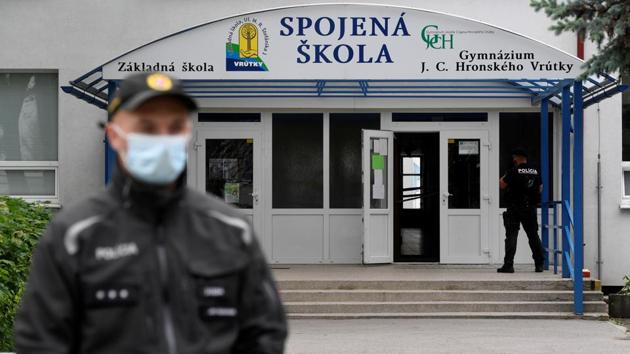 Police officers wearing face masks guard the area at the scene of a reported assault on staff at a school in Vrutky, Slovakia, June 11, 2020. (Reuters photo) Police officers wearing face masks guard the area at the scene of a reported assault on staff at a school in Vrutky, Slovakia, June 11, 2020. (Reuters photo)