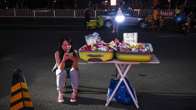 There has been some online rejoicing of street vending with hashtags including “If you were a street vendor, what would you sell?” and “Everyone is street selling” getting millions of views on Weibo. Even so, photos of streets crammed with stalls and car boot sales have been going viral on Weibo, where many first-time stall holders -- often millennials -- complained business was slow. (GREG BAKER / AFP)