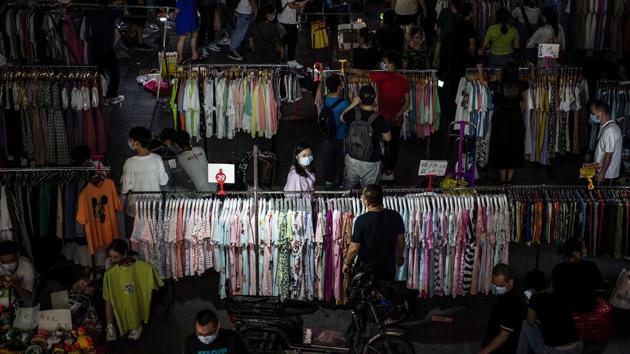 People at an outdoor market in Wuhan on June 10. “Although it seems sensible to relax regulations on self-employment activity in times of recession... I am sceptical that promoting a street vendor economy will substantially boost consumption,” Albert Park, an economics professor at the Hong Kong University of Science and Technology told AFP. (AFP)