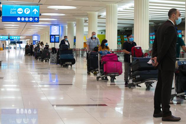 Passengers wearing masks due to the coronavirus pandemic wait at ticketing for flights at Dubai International Airport's Terminal 3 in Dubai, United Arab Emirates (AP) Passengers wearing masks due to the coronavirus pandemic wait at ticketing for flights at Dubai International Airport's Terminal 3 in Dubai, United Arab Emirates (AP)