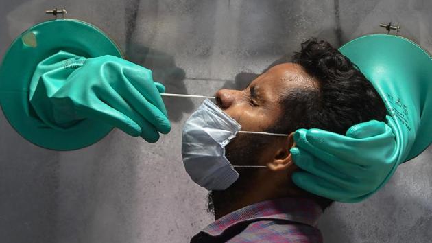 A medic collects swab sample of a suspected Covid-19 patient for a test at a government hospital in New Delhi on Wednesday. (PTI File Photo) A medic collects swab sample of a suspected Covid-19 patient for a test at a government hospital in New Delhi on Wednesday. (PTI File Photo)
