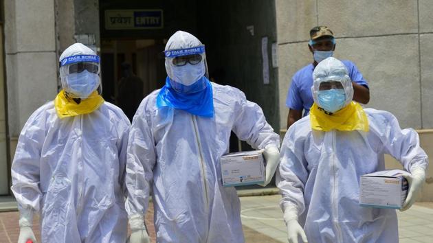 Medics arrive to take samples of suspected Covid-19 patients for lab tests at a government hospital in New Delhi on Wednesday. (PTI) Medics arrive to take samples of suspected Covid-19 patients for lab tests at a government hospital in New Delhi on Wednesday. (PTI)
