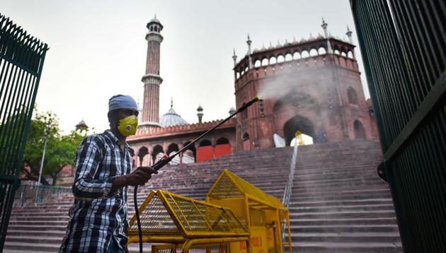 A worker sanitizing the area of the Jama Masjid complex with authorities contemplating closing it to the public due to rising coronavirus cases in New Delhi on Wednesday.(Sanchit Khanna/HT PHOTO) A worker sanitizing the area of the Jama Masjid complex with authorities contemplating closing it to the public due to rising coronavirus cases in New Delhi on Wednesday.(Sanchit Khanna/HT PHOTO)