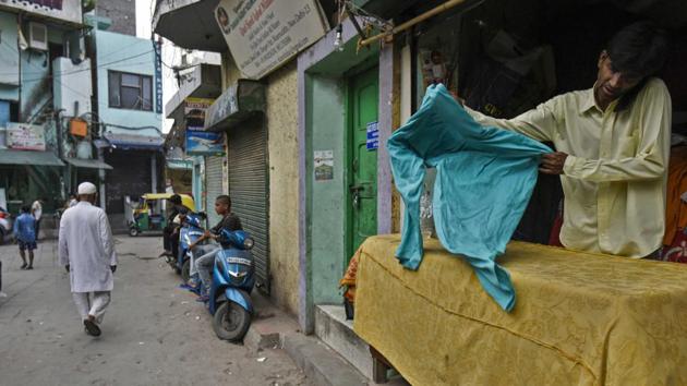 A man speaks on the phone in his shop in Nizamuddin on June 10. The once-bustling lanes of Nizamuddin Basti lay deserted on Wednesday. (Biplov Bhuyan / HT Photo)