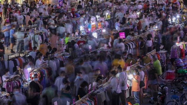 Street vendors sell clothes in an outdoor market in Wuhan. While not backed by any formal policy, Chinese Premier Li Keqiang’s comments spurred people nationwide to set up street stalls, including on the back of bikes and even on pavements. But just as they took to the streets, they were shooed out of central hotspots in Beijing. (AFP)
