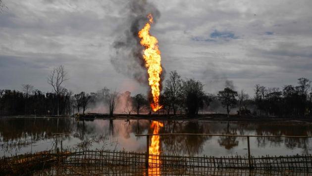 Flames and smoke arise from a well run by state-owned Oil India Limited in Tinsukia, Assam on June 10. Two firefighters’ bodies were found in a pond as the towering blaze reached for the sky from the Baghjan gas well. It could be nearly four weeks before the blowout is reigned in, the company said in a statement yesterday. (Biju Boro / AFP) Flames and smoke arise from a well run by state-owned Oil India Limited in Tinsukia, Assam on June 10. Two firefighters’ bodies were found in a pond as the towering blaze reached for the sky from the Baghjan gas well. It could be nearly four weeks before the blowout is reigned in, the company said in a statement yesterday. (Biju Boro / AFP)