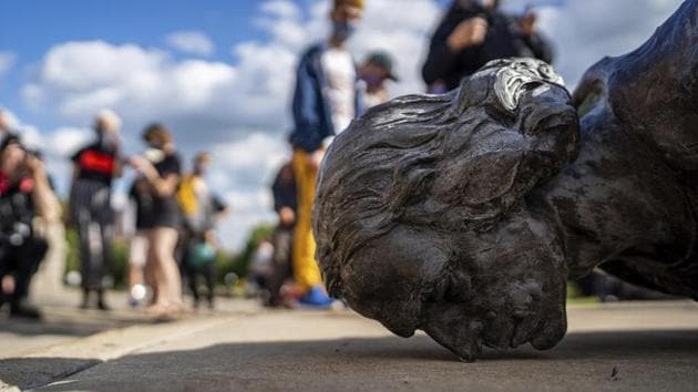 People stand around the fallen Christopher Columbus statue at the Minnesota state Capitol in St. Paul, Minn., Wednesday (AP Photo) People stand around the fallen Christopher Columbus statue at the Minnesota state Capitol in St. Paul, Minn., Wednesday (AP Photo)