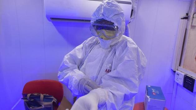 A medical professional gears up in a bus converted into a mobile Covid-19 testing clinic at Government Officers flats in Vasant Kunj. On the basis of the current doubling rate of 12.6 days, the Delhi health department has projected that the number of active cases in Delhi will touch 60,004 by June 30 and 319,237 by July 31, reported HT. (Sonu Mehta / HT Photo) A medical professional gears up in a bus converted into a mobile Covid-19 testing clinic at Government Officers flats in Vasant Kunj. On the basis of the current doubling rate of 12.6 days, the Delhi health department has projected that the number of active cases in Delhi will touch 60,004 by June 30 and 319,237 by July 31, reported HT. (Sonu Mehta / HT Photo)