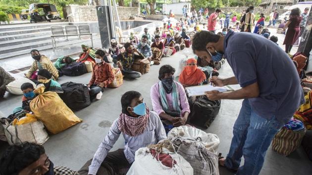 Stranded migrants sit in queue before they board bus to go back to their native places from Wakdewadi Bus Depot, in Pune on Thursday. (Pratham Gokhale/HT Photo) Stranded migrants sit in queue before they board bus to go back to their native places from Wakdewadi Bus Depot, in Pune on Thursday. (Pratham Gokhale/HT Photo)