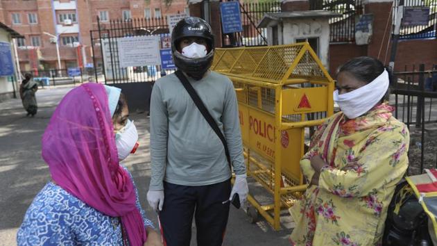 Relatives of Covid-19 patients stand outside a coronavirus designated hospital in New Delhi on Wednesday. (AP Photo) Relatives of Covid-19 patients stand outside a coronavirus designated hospital in New Delhi on Wednesday. (AP Photo)